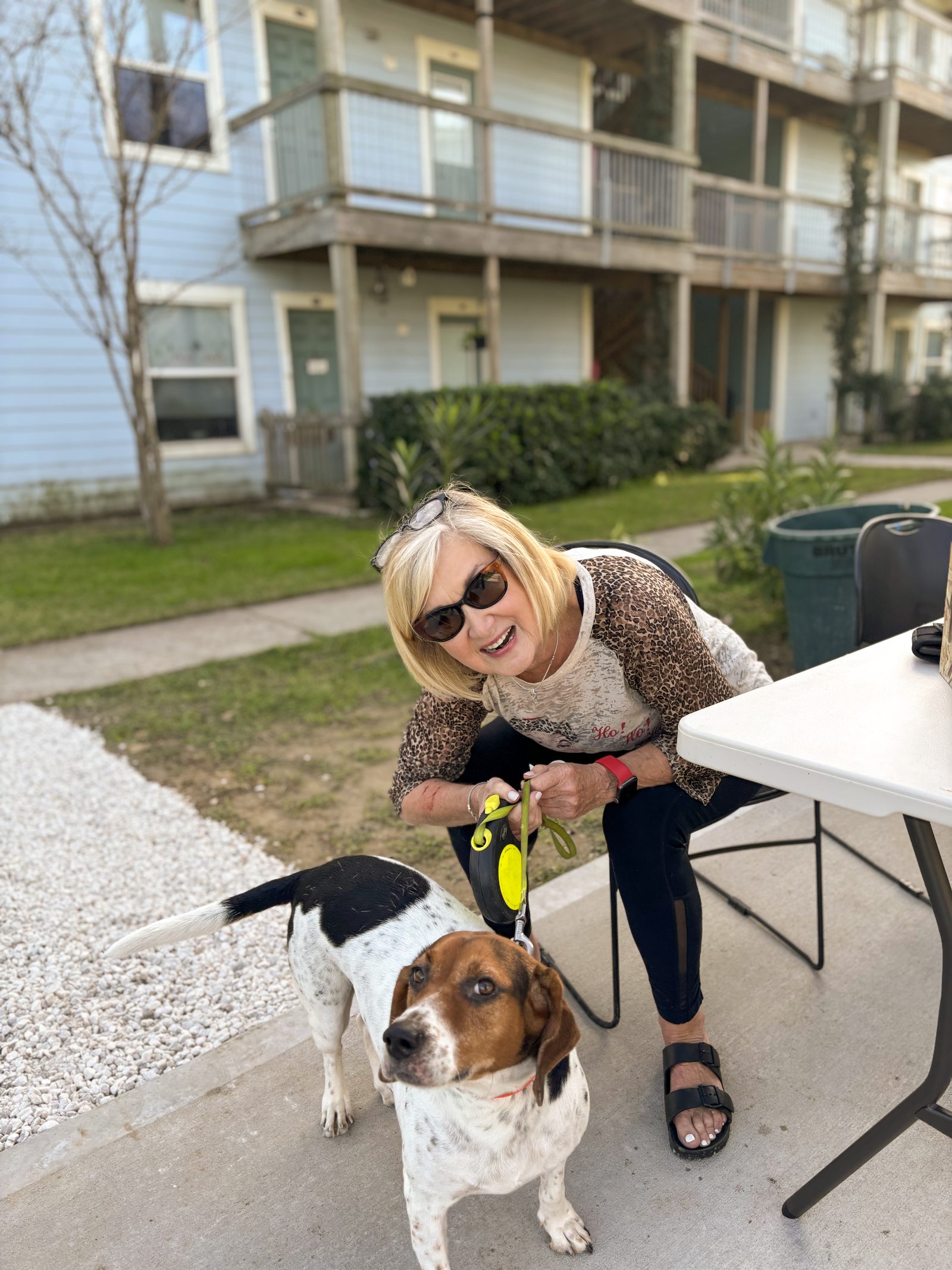 Resident washing a dog at the outdoor pet station