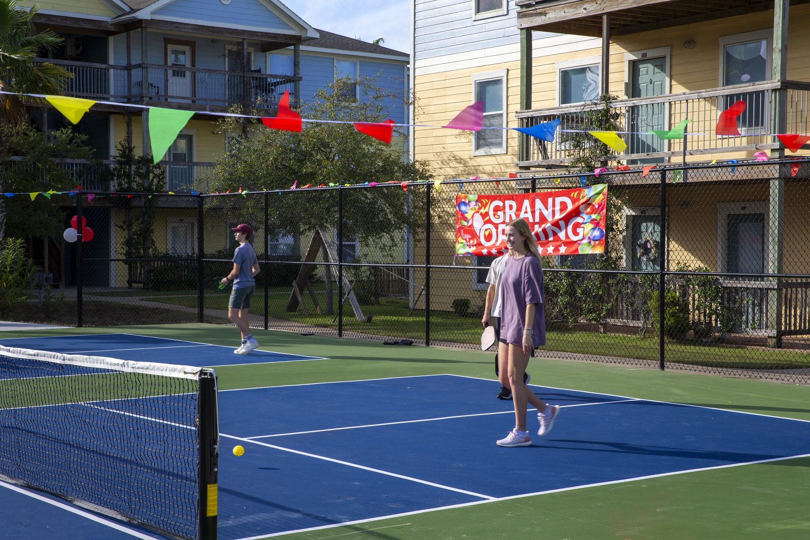 Resident playing pickleball on the UAG court