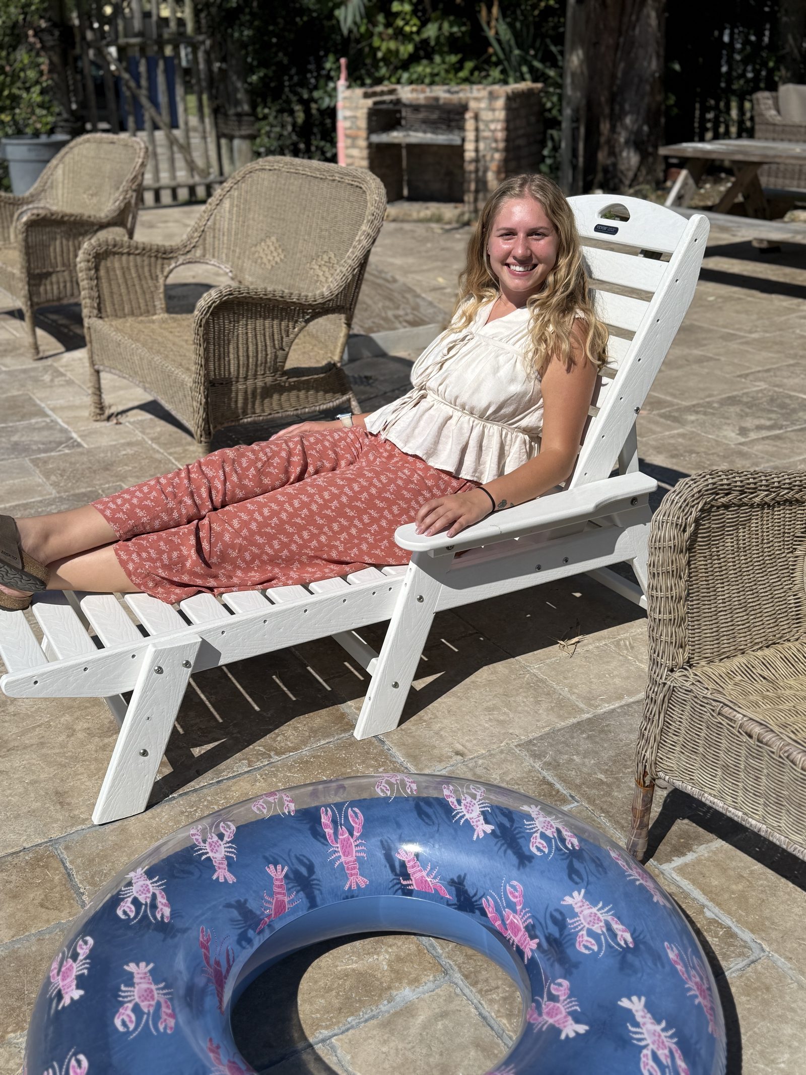 Resident relaxing in a chair on the UAG grounds